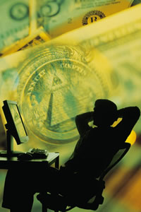 man at desk with image of money in background