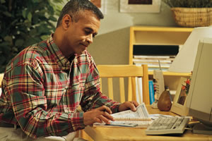 man looking over apartment applications at table