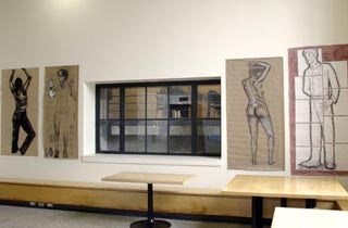 A photo of four body drawings hung on the wall.