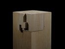 Photograph of bass wood cube model on basewith shifted portions of the cube.