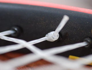 Photo of the edge of a tennis racket.