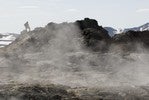 Student walking above steam from geothermal spring.