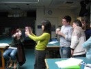 Photo of a student viewing an object through a pinhole.