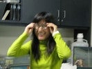 Photo of a student trying on eyeglasses.