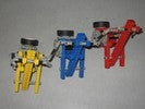 A Lego robot with three tall triangular-framed units.