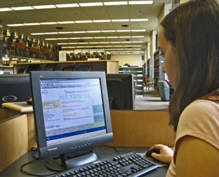 A student at a computer terminal in the library.