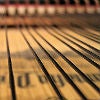 Close up image of piano strings inside a piano.