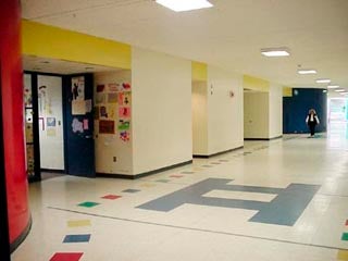 A photo of a wide school hallway.