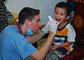 US Navy 100812-N-3589B-028 Hospital Corpsman 2nd Class Joseph Smith performs a pre-surgery check on a patient.jpg